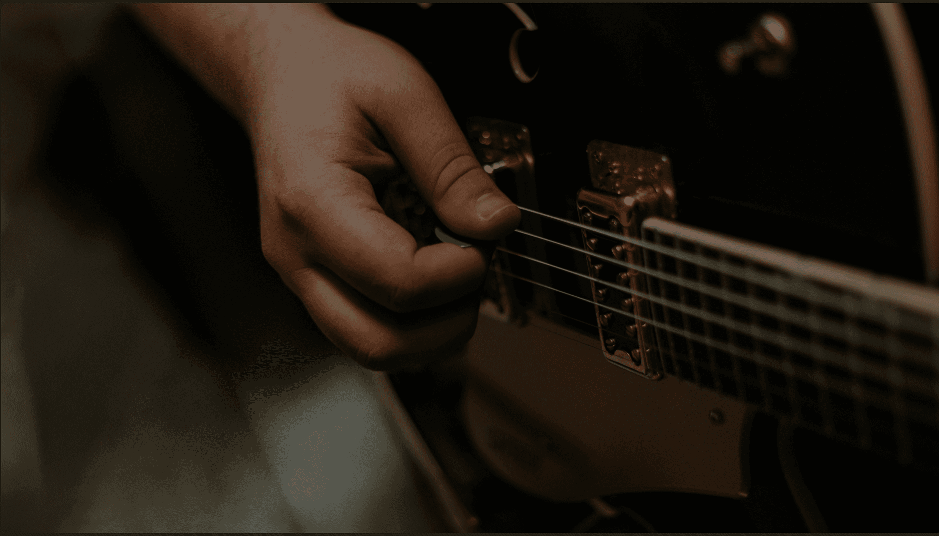 Close-up of a hand playing electric guitar - the craft behind Groovity